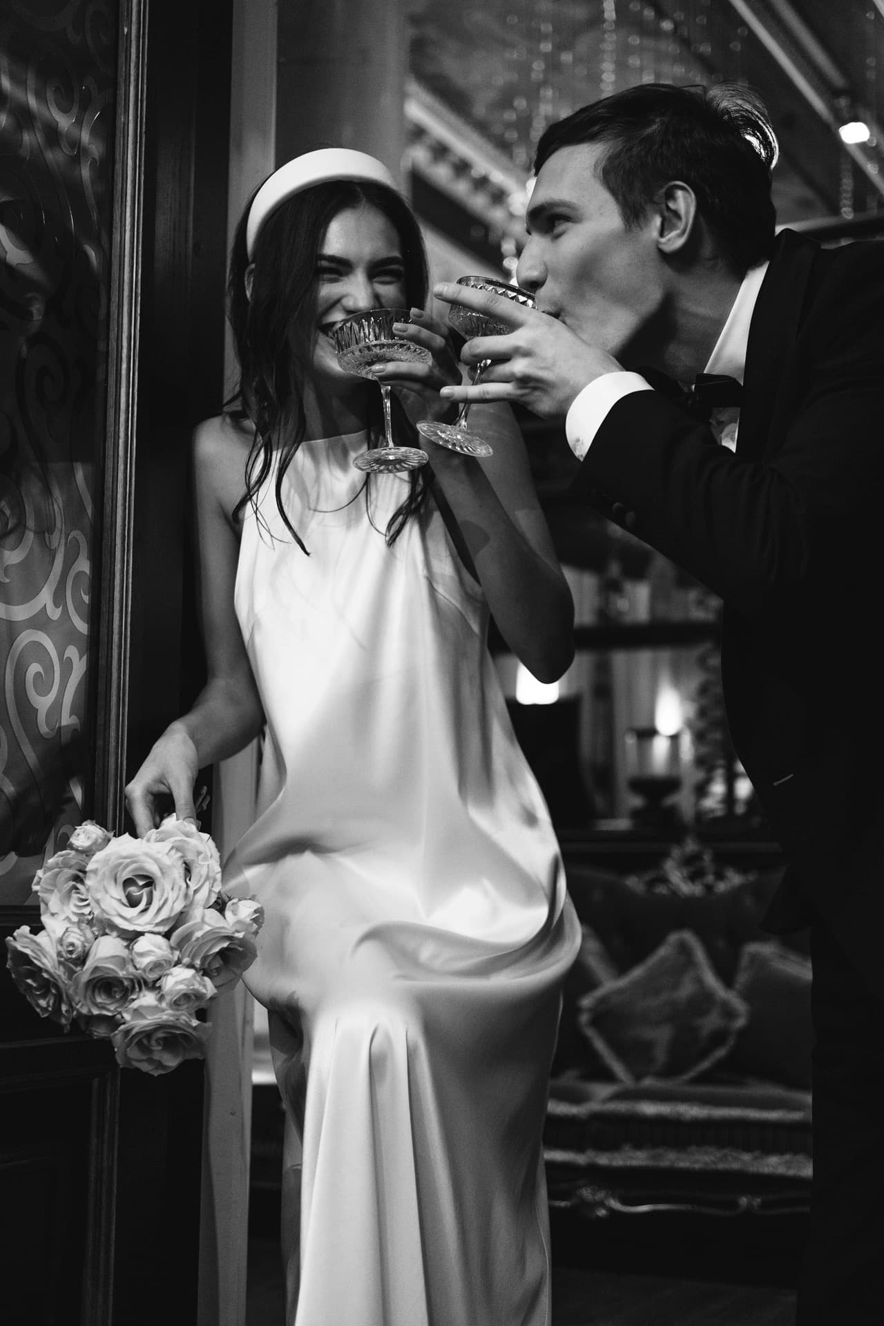 Bride and groom toasting with champagne, in black and white